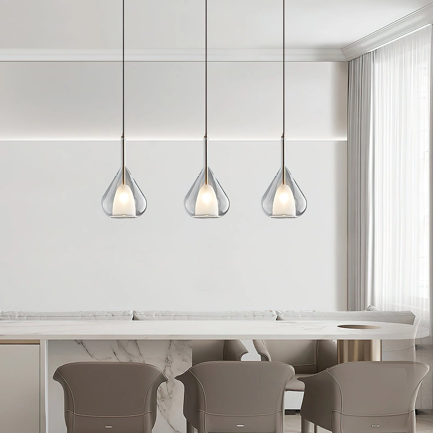Nordic style pendant lamp with a clear raindrop design and starlight effect hanging in a modern interior featuring wooden furniture and grey cabinetry.