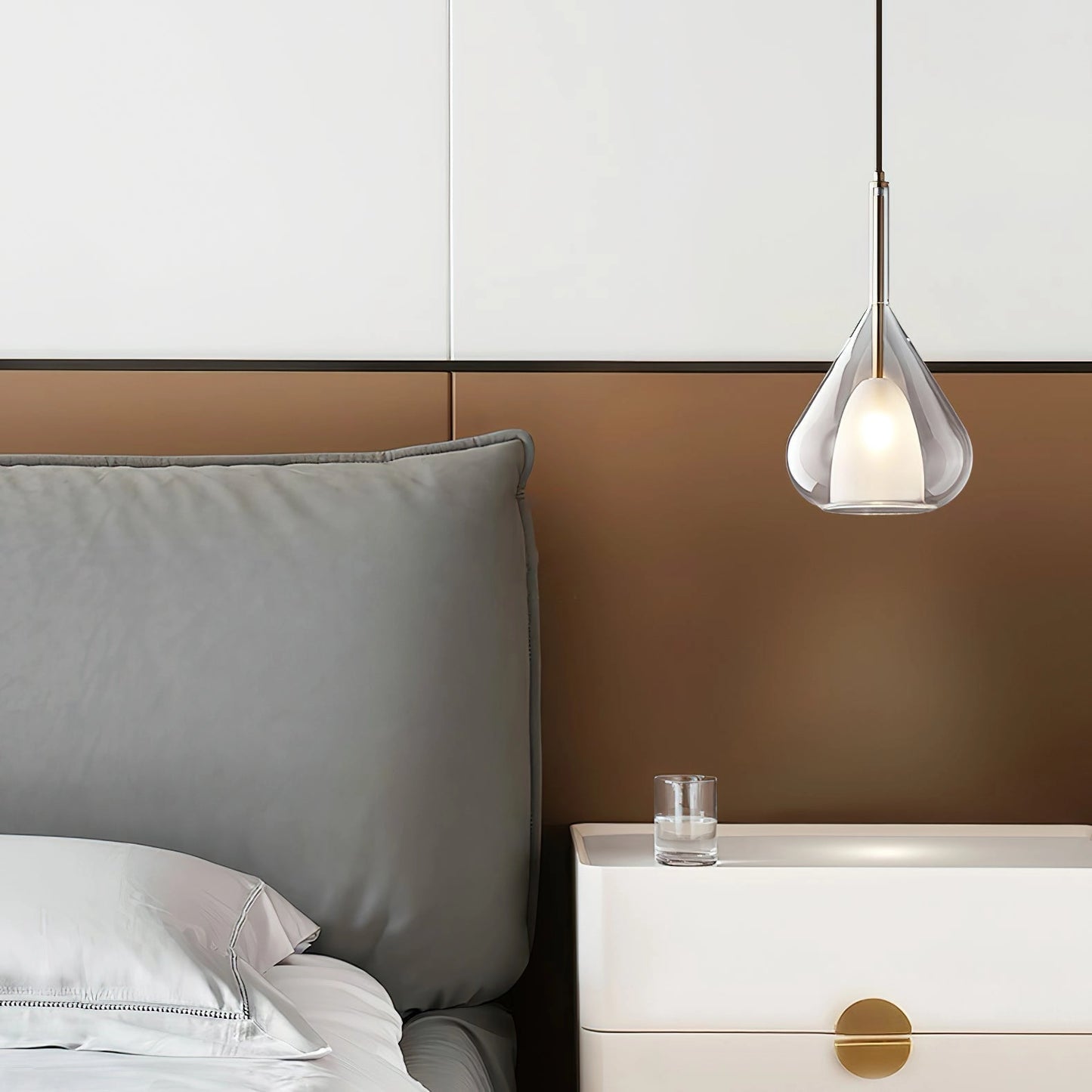 Nordic style pendant lamp with a clear raindrop design and a starlight effect, illuminating a cozy interior space with wood accents and minimalist grey decor.