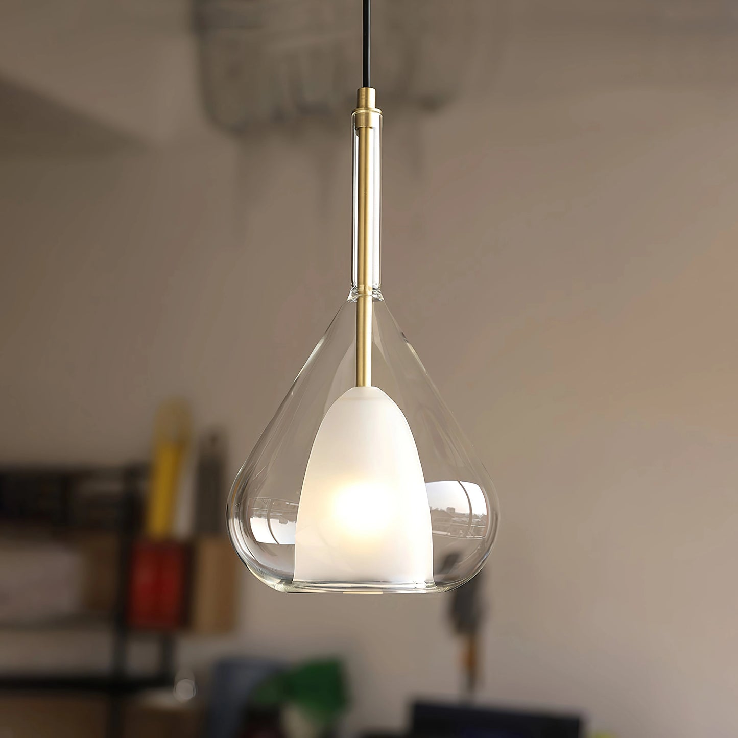 Nordic style pendant lamp with a clear raindrop design and starlight effect, hanging from the ceiling, featuring a circular composite material and metal fixture.