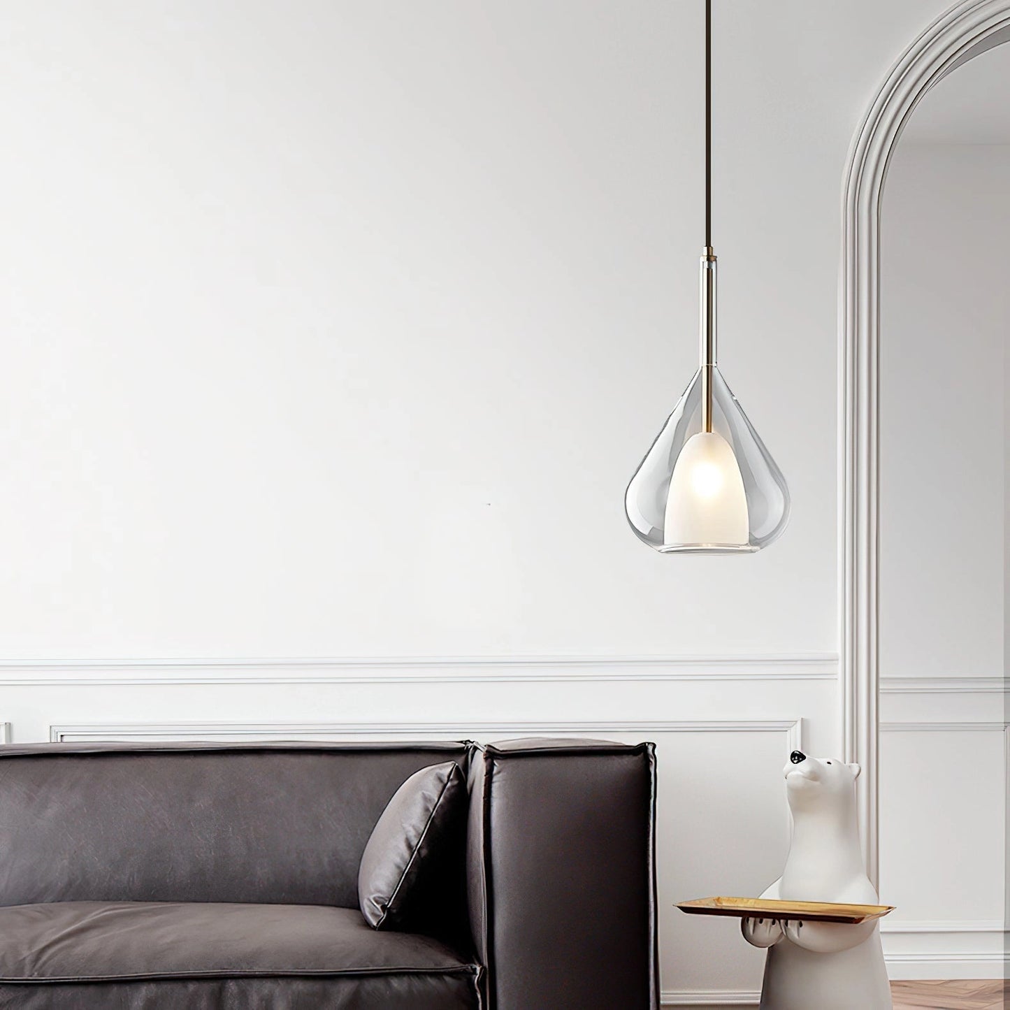 Nordic style pendant lamp with clear raindrop design and starlight effect, hanging above a cozy grey couch with wooden flooring in a modern living room setting.