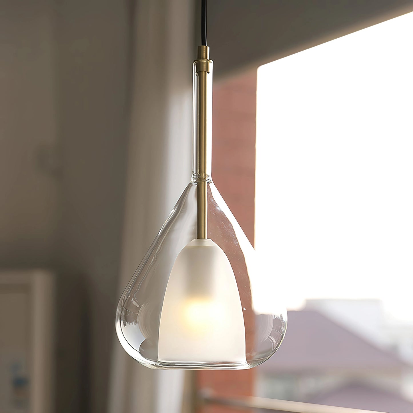 Pendant lamp with a clear raindrop design, featuring a starlight effect and a Nordic style, hanging from a wooden ceiling fixture.