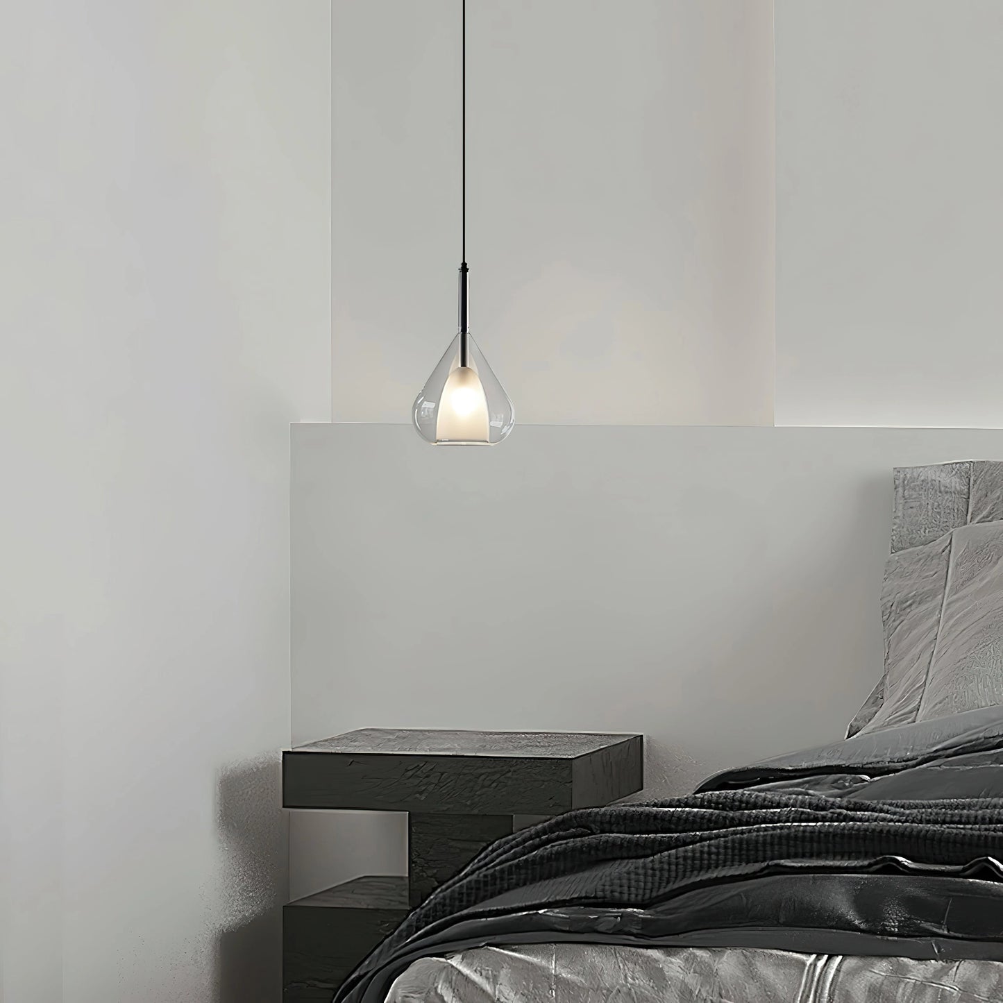 Nordic style pendant lamp with clear raindrop design and starlight effect, hanging in a modern room with grey walls and wooden flooring.