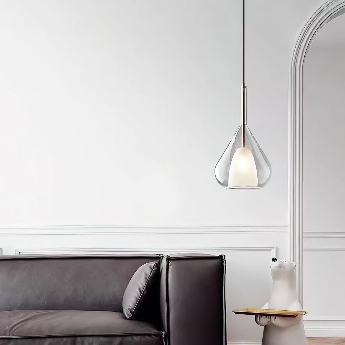 Nordic style pendant lamp with a clear raindrop design and starlight effect, featuring a wooden accent, hanging in a modern grey-toned interior.