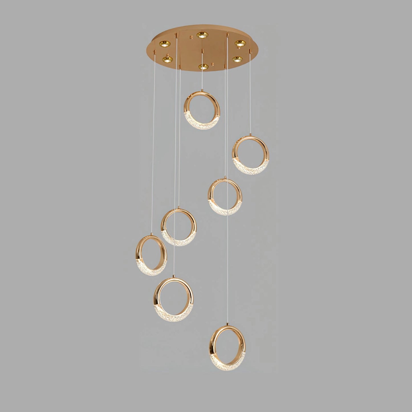 Modern gold pendant lamp chandelier with seven heads, cool light, and intricate metal design hanging from the ceiling.