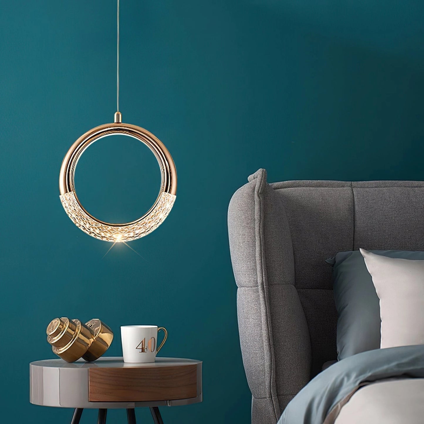 Modern Pendant Lamp Dante hanging over a stylish dining table set in an elegantly designed interior with comfortable furniture and aqua accents.