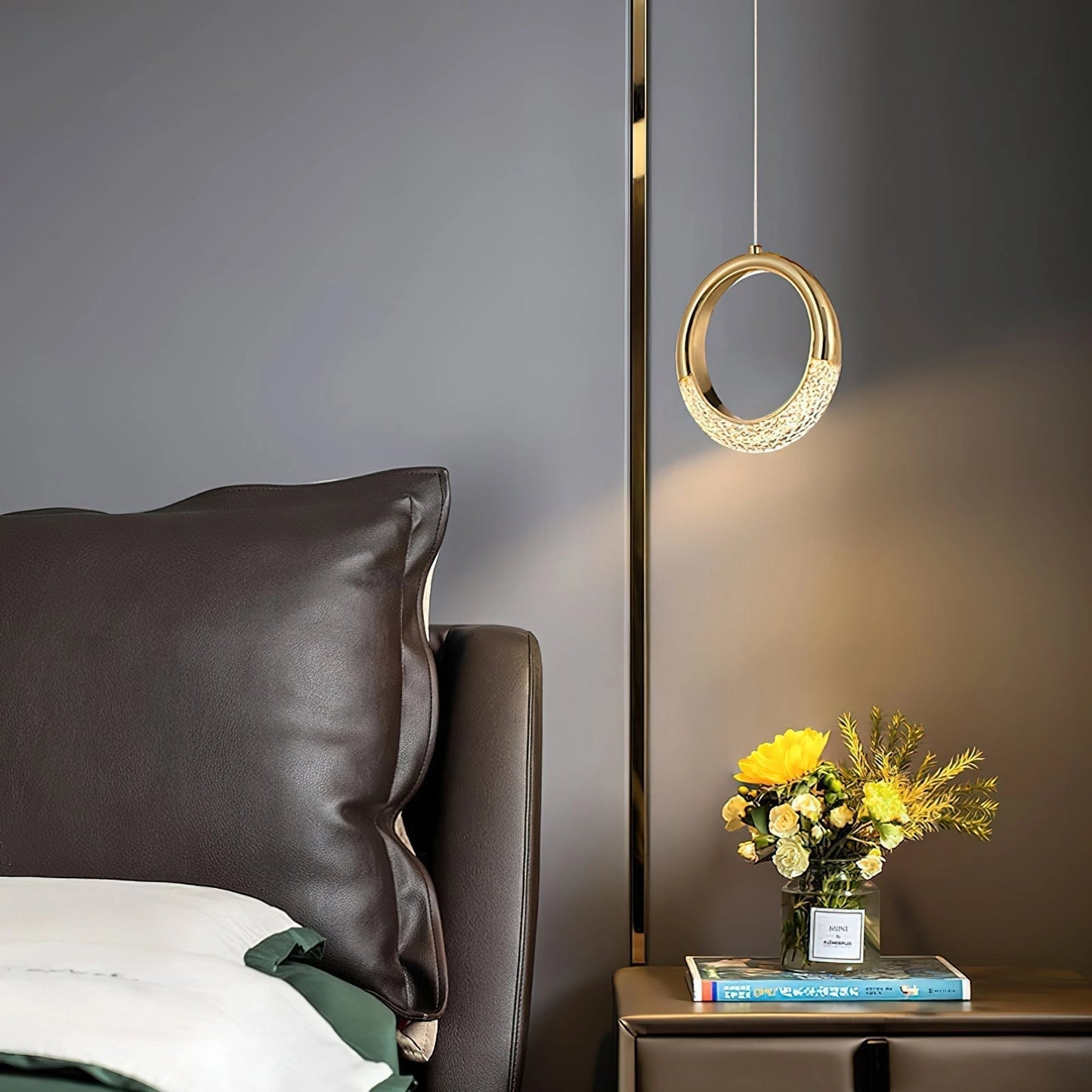 Modern pendant lamp Dante chandelier hanging above a cozy living room with a couch, picture frame, and vase.