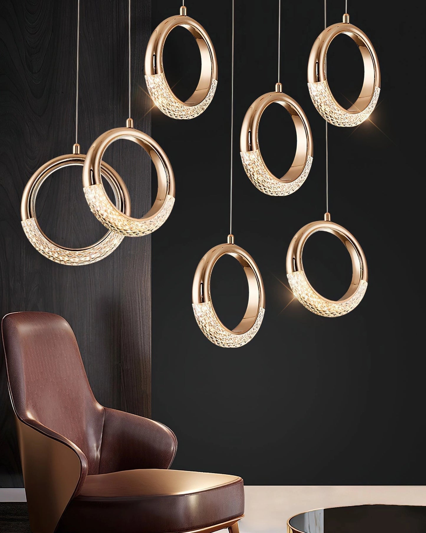 Modern Pendant Lamp Dante with gold accents, hanging above a brown couch. The fixture features a rectangular wooden design.