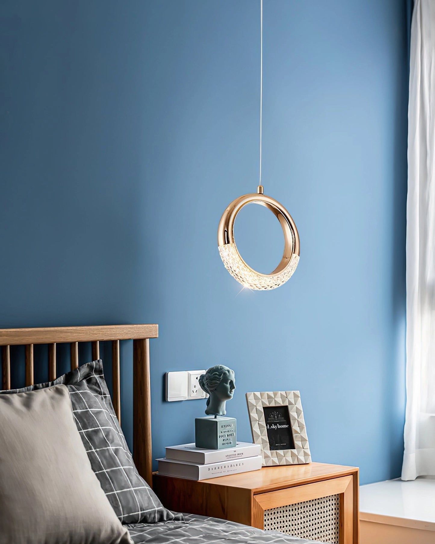 Modern Pendant Lamp Dante Chandelier with blue and wooden elements, hanging in a stylishly designed interior room with mirrored accents and comfortable furnishings.