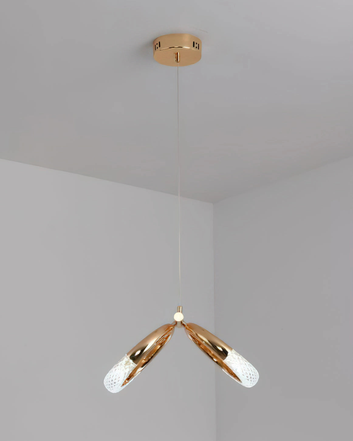 Modern Pendant Lamp Dante chandelier with wooden accents and metal ceiling fixture, emitting a warm light.