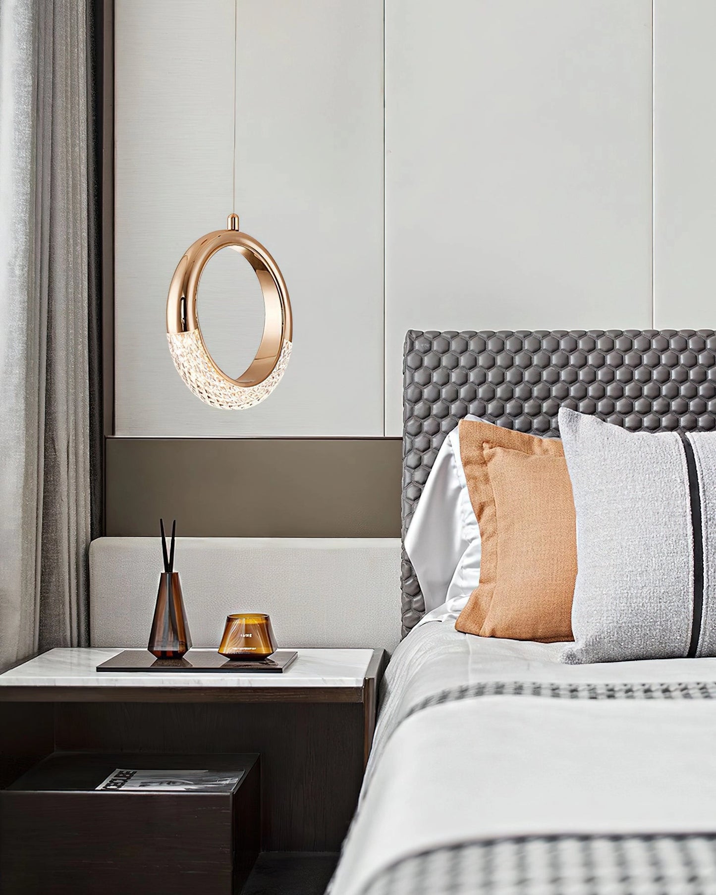 Modern Pendant Lamp Dante chandelier hanging in a stylishly furnished room with grey tones, featuring wood elements, a rectangular mirror, and a comfortable bed with pillows.
