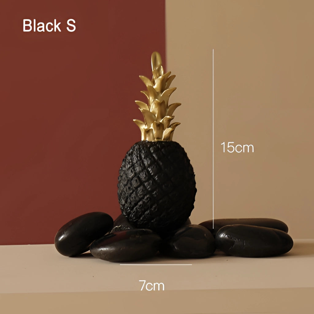 Golden resin pineapple-shaped ornament in black, small size, used as Nordic home decor, resembling ananas plant.