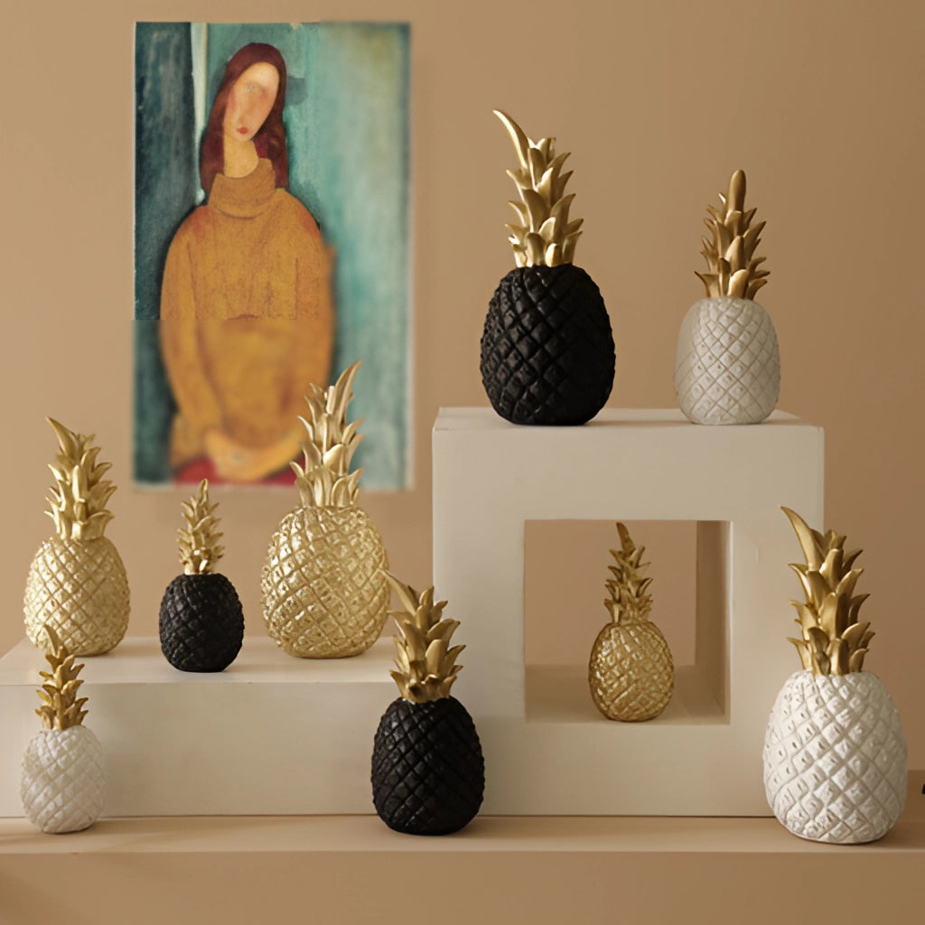 Golden resin pineapple-shaped ornament for Nordic home decor displayed in a stylish still life setting.