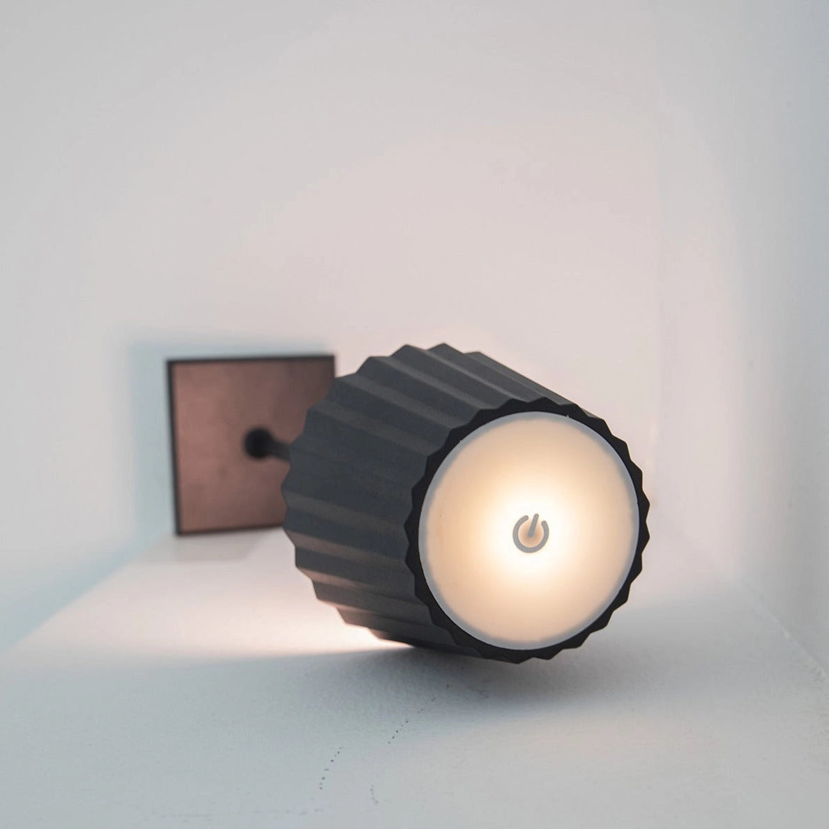 Cordless LED table lamp with stepless dimming and quick charging, placed on a wooden surface.
