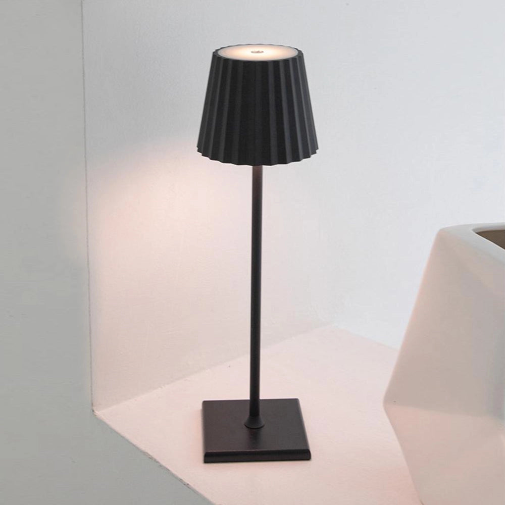 Cordless LED table lamp with stepless dimming and quick charging, featuring a sleek metal design and modern lampshade.