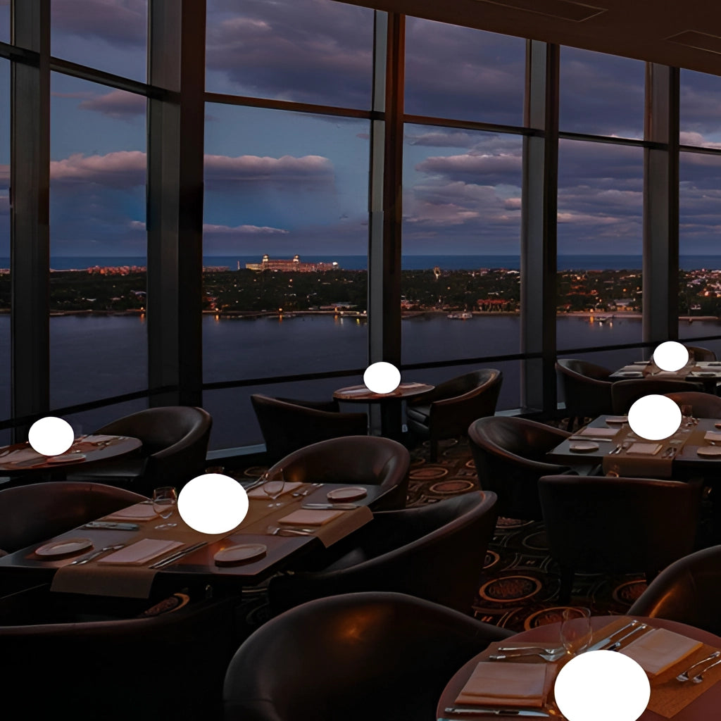 Rechargeable cordless LED moon table lamp with 16 color options on a table near a window with a view of skyscrapers.