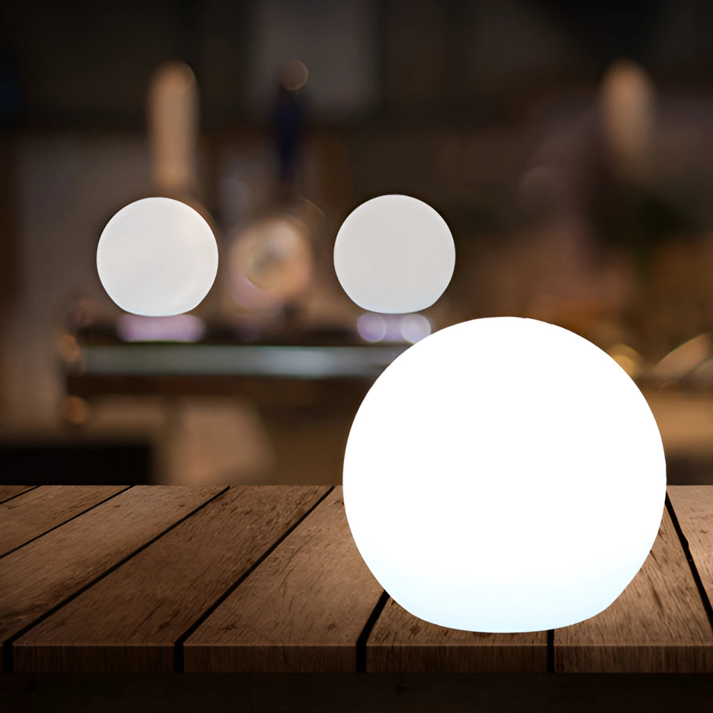 Rechargeable cordless LED moon table lamp with 16 color options, featuring a wooden base and emitting a soft, adjustable light.