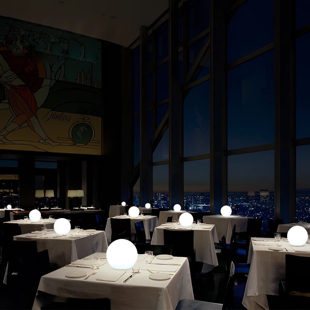 Rechargeable Cordless LED Moon Table Lamp with 16 color options on a dining table in a modern interior setting.