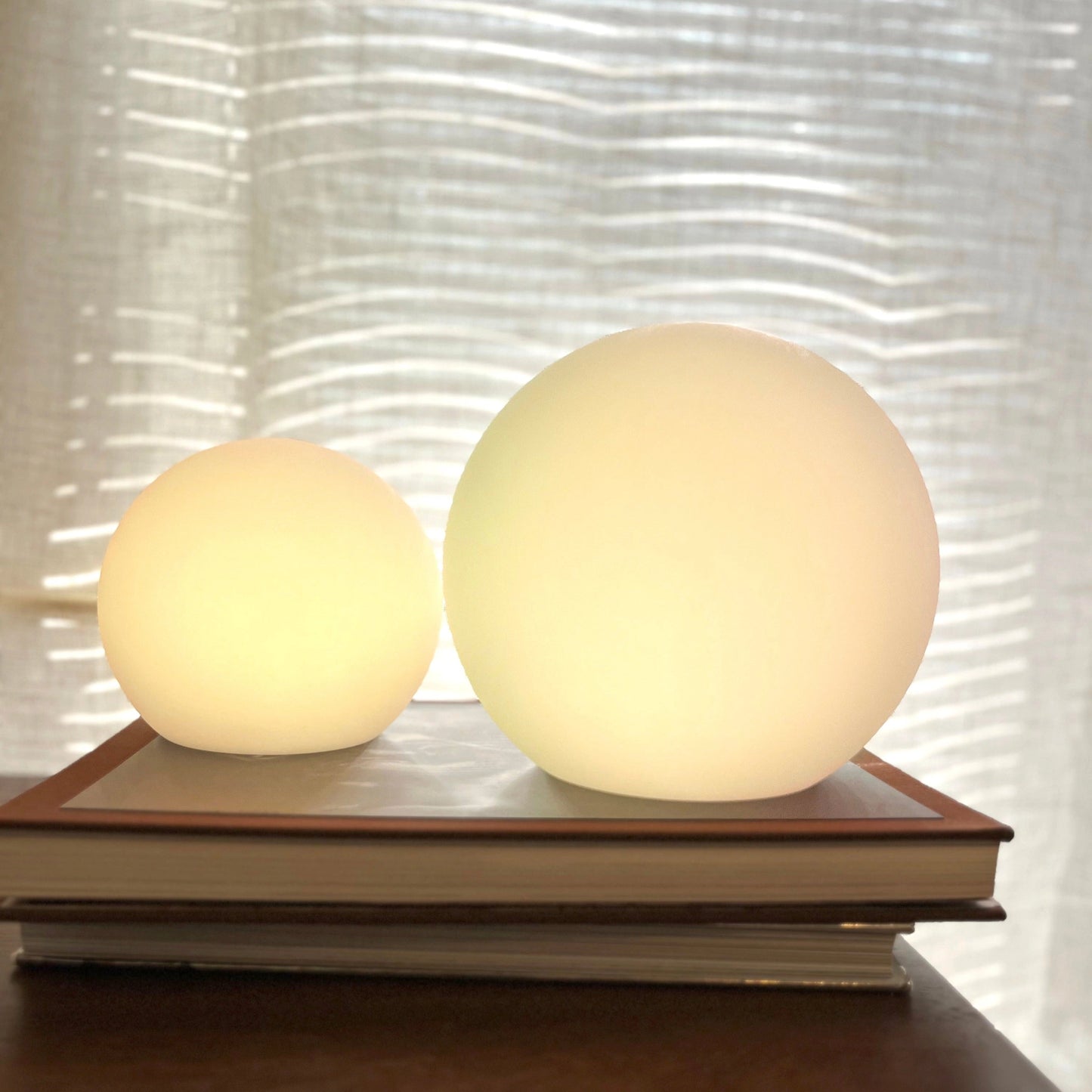 Rechargeable cordless LED moon table lamp with 16 color options on a wooden table.