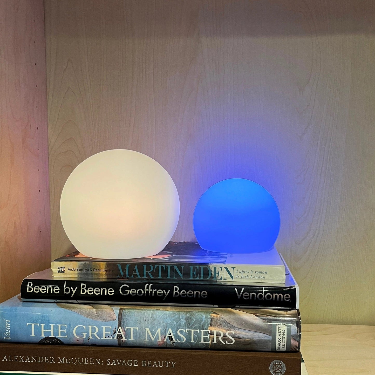 Rechargeable Cordless LED Moon Table Lamp with 16 Color Options, featuring a wooden stand on a hardwood surface with a rectangular background.