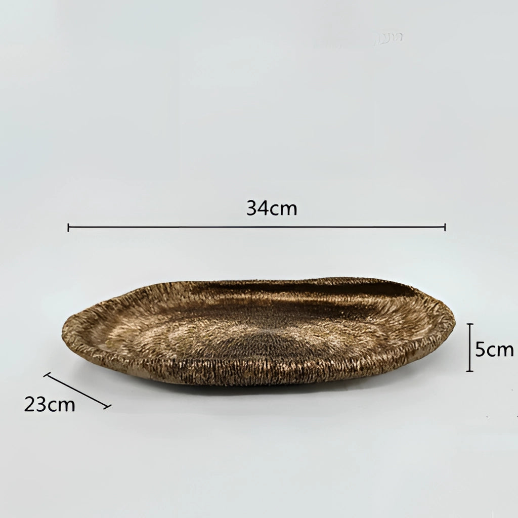 A resin nature-inspired decorative bowl with a glossy finish, featuring an oval shape and intricate, metallic-like patterns resembling natural elements, displayed against a neutral background.