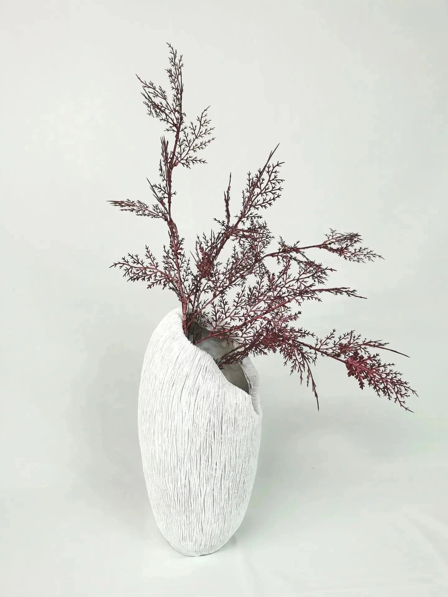 A resin nature-inspired decorative bowl featuring intricate twig and plant designs, artistically crafted to resemble a natural artifact, displayed on a table.
