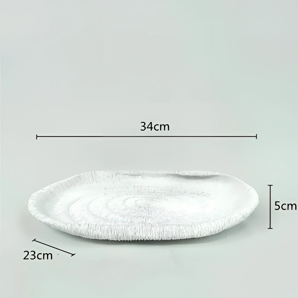 Nature-inspired decorative bowl made of resin, oval-shaped with synthetic rubber texture.