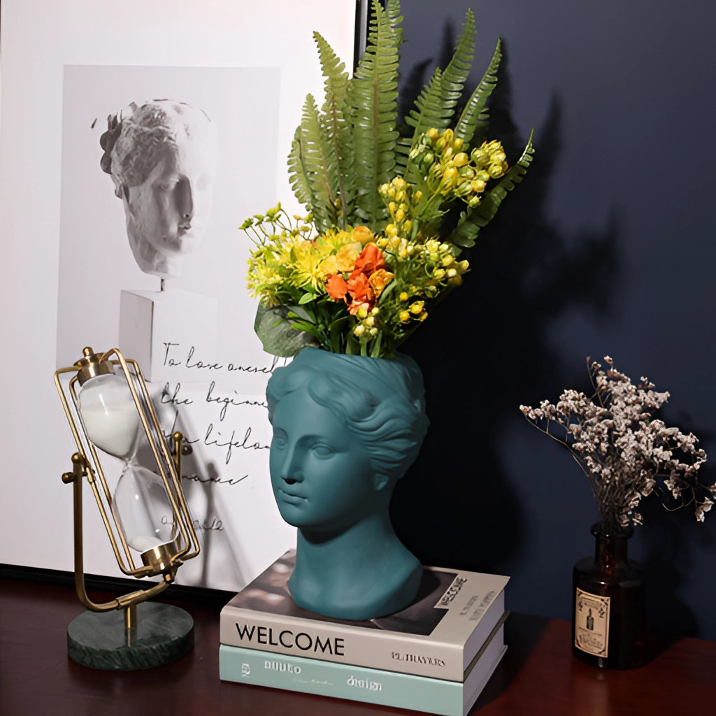 Resin Neoclassical Venus Vase in Blush Pink with an elegant flower arrangement, showcasing a blend of art and sculpture.
