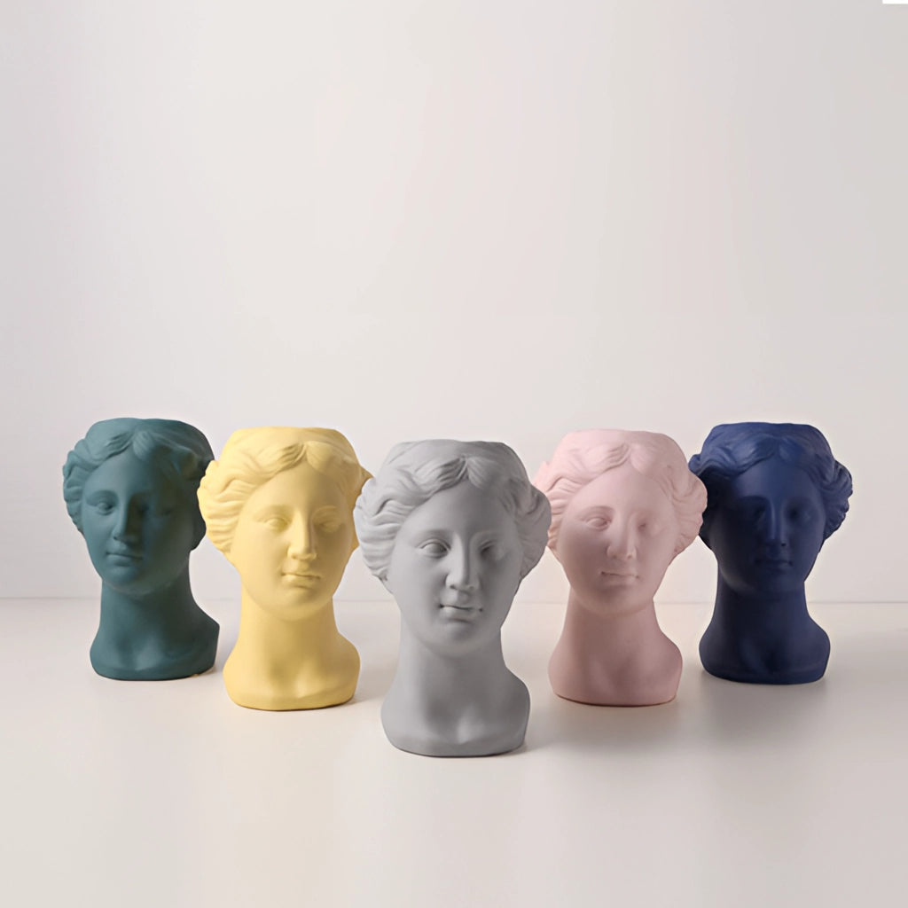 Neoclassical Venus vase made of resin in blush pink, teal, and grey options, resembling an artistic sculpture with intricate details.