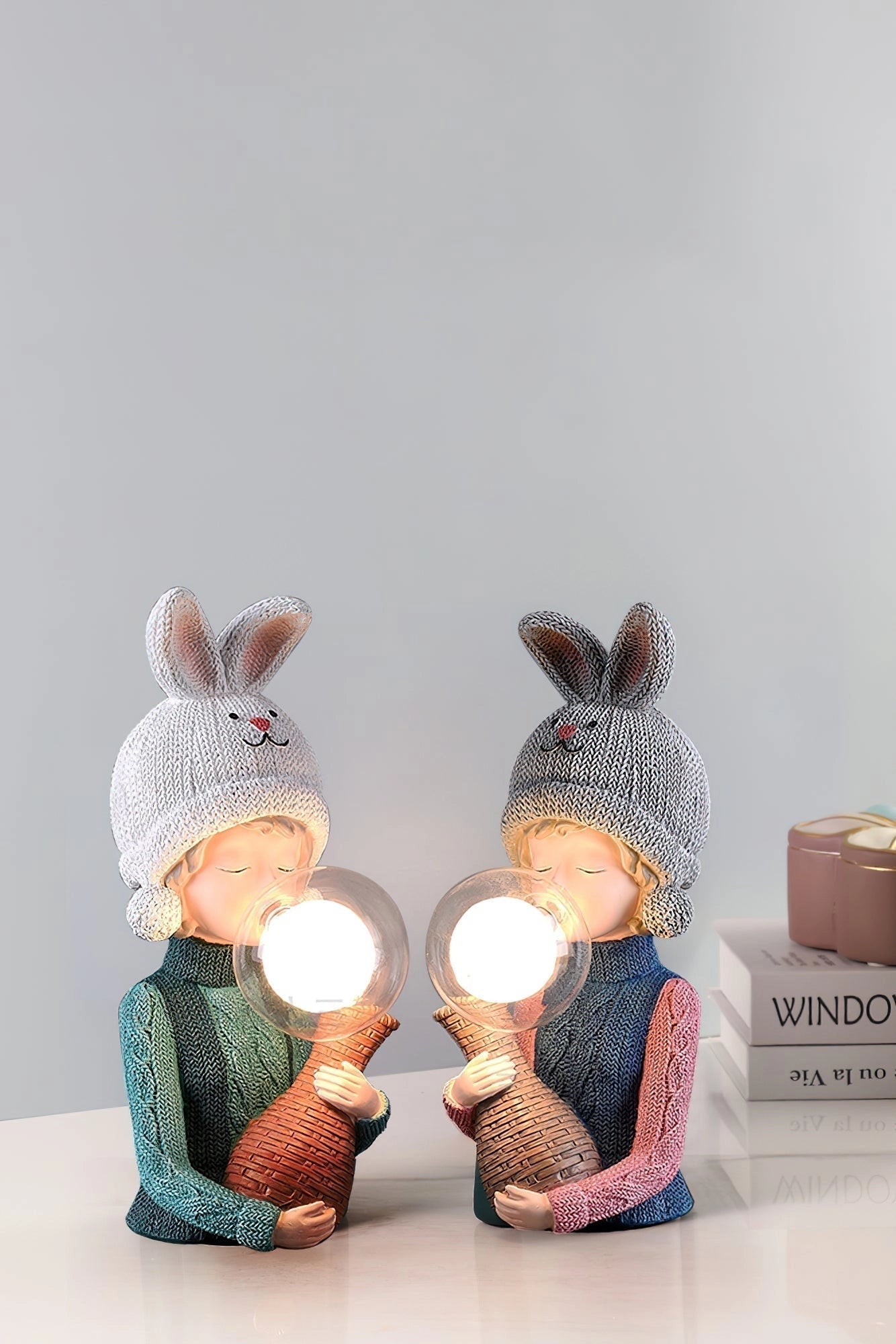 A resin table lamp featuring an elegant rabbit girl figure with dual glass lampshades, designed to add a touch of art and creativity to any room.