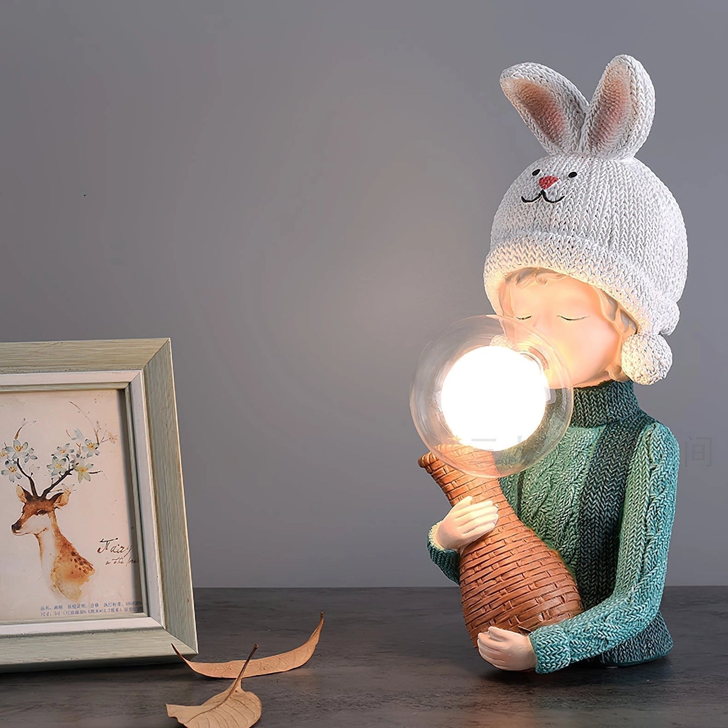 Resin table lamp featuring an elegant rabbit girl figurine with a dual glass lampshade, surrounded by wooden elements and artistic decor.
