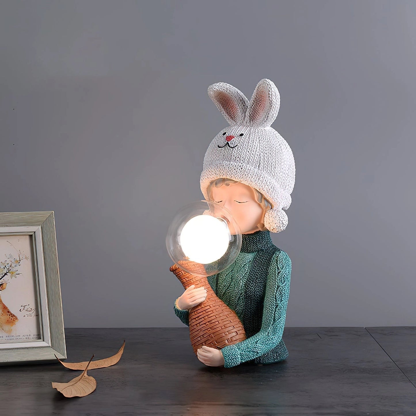 Resin table lamp featuring an elegant rabbit girl design with a dual glass lampshade, positioned on a wooden base.