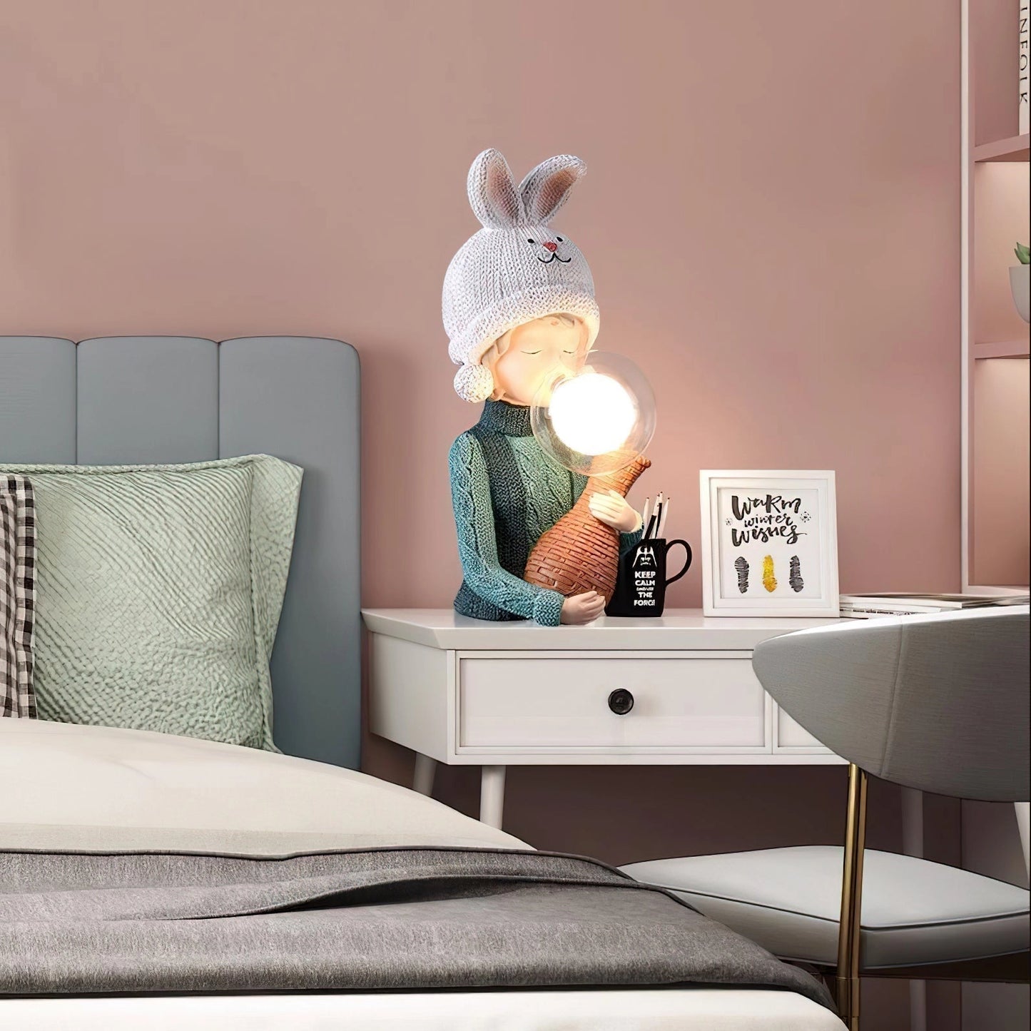 Resin table lamp featuring an elegant rabbit girl design with dual glass lampshades, placed on a wooden rectangular table in a stylish interior setting.