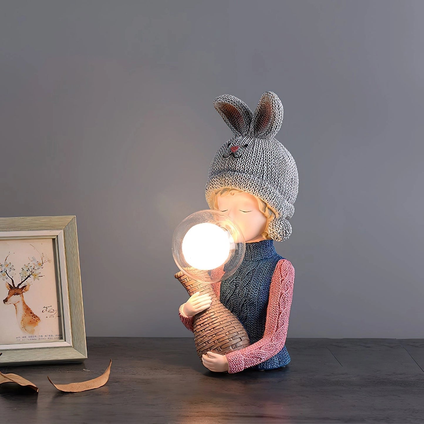 Resin table lamp featuring an elegant rabbit girl figure with a dual glass lampshade, placed on a wooden surface.