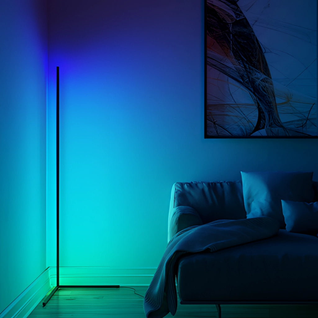 A modern living room featuring an RGB corner floor lamp with LED light, emitting a mix of blue and purple hues, placed near a comfortable couch.