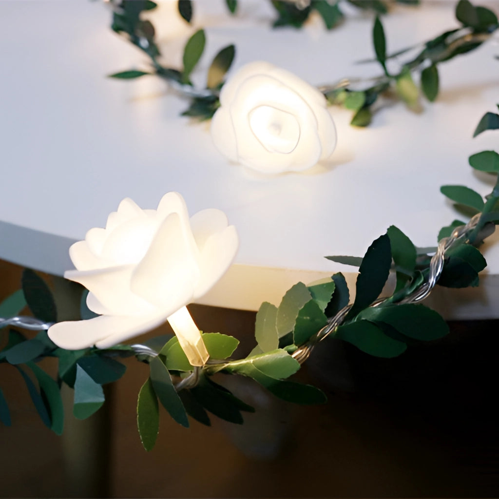 Battery-operated LED garland featuring artificial rose flowers with petals and branches, ideal for decoration and flower arranging.