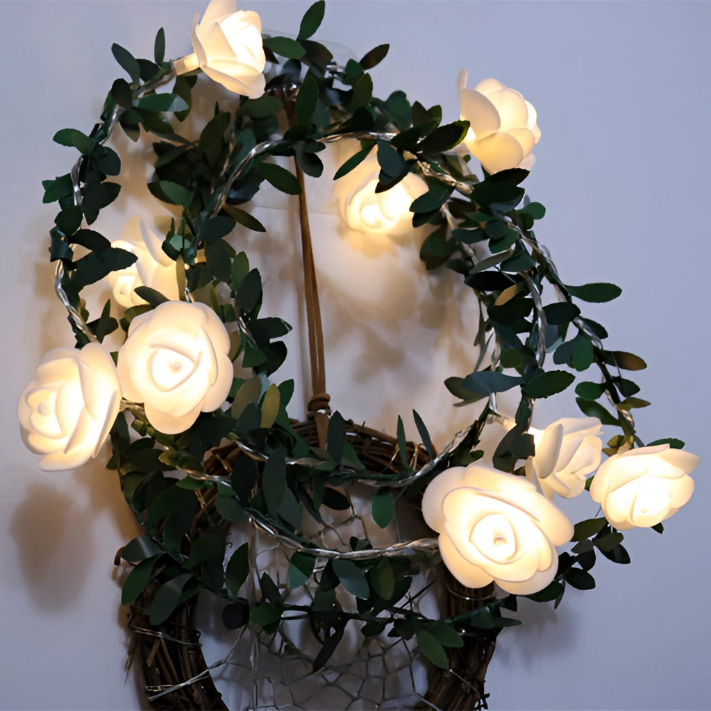 Battery-operated LED rose flower string lights, featuring realistic pink rose petals on a garland of twigs and branches.