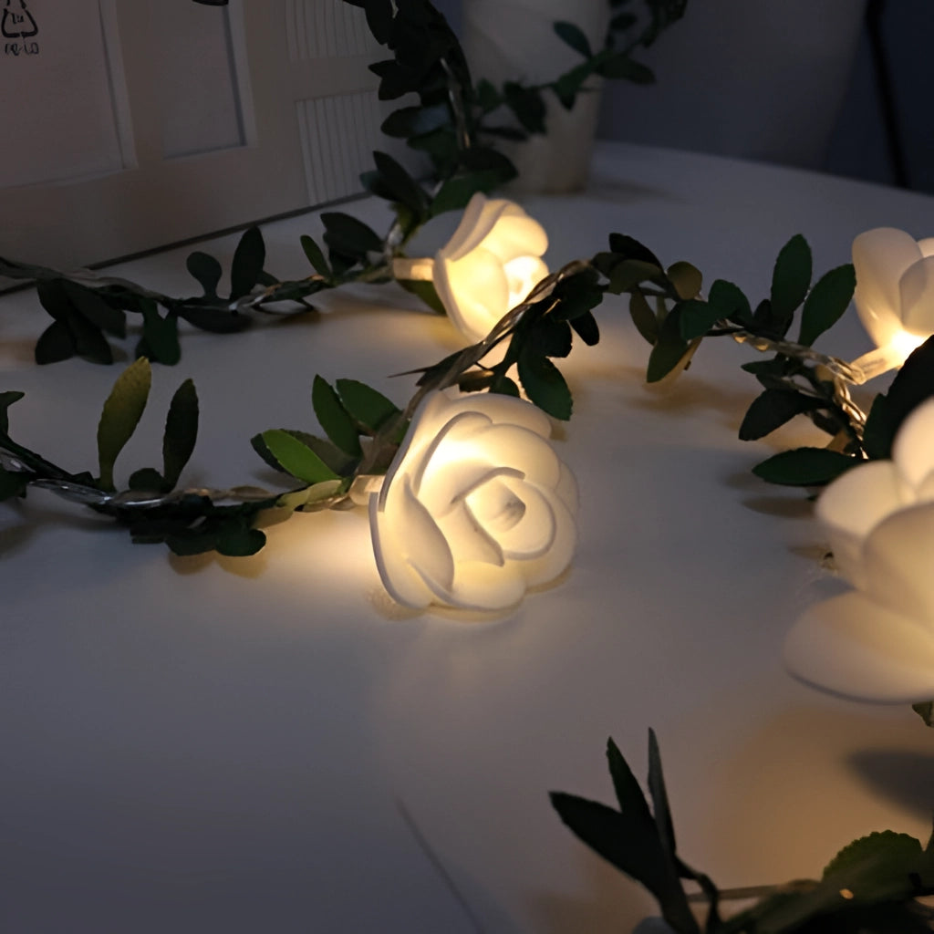 Battery-operated LED rose flower string lights garland with 40 LEDs on a 20-foot long wire, featuring realistic floral design and suitable for decoration at events, parties, or home interiors.