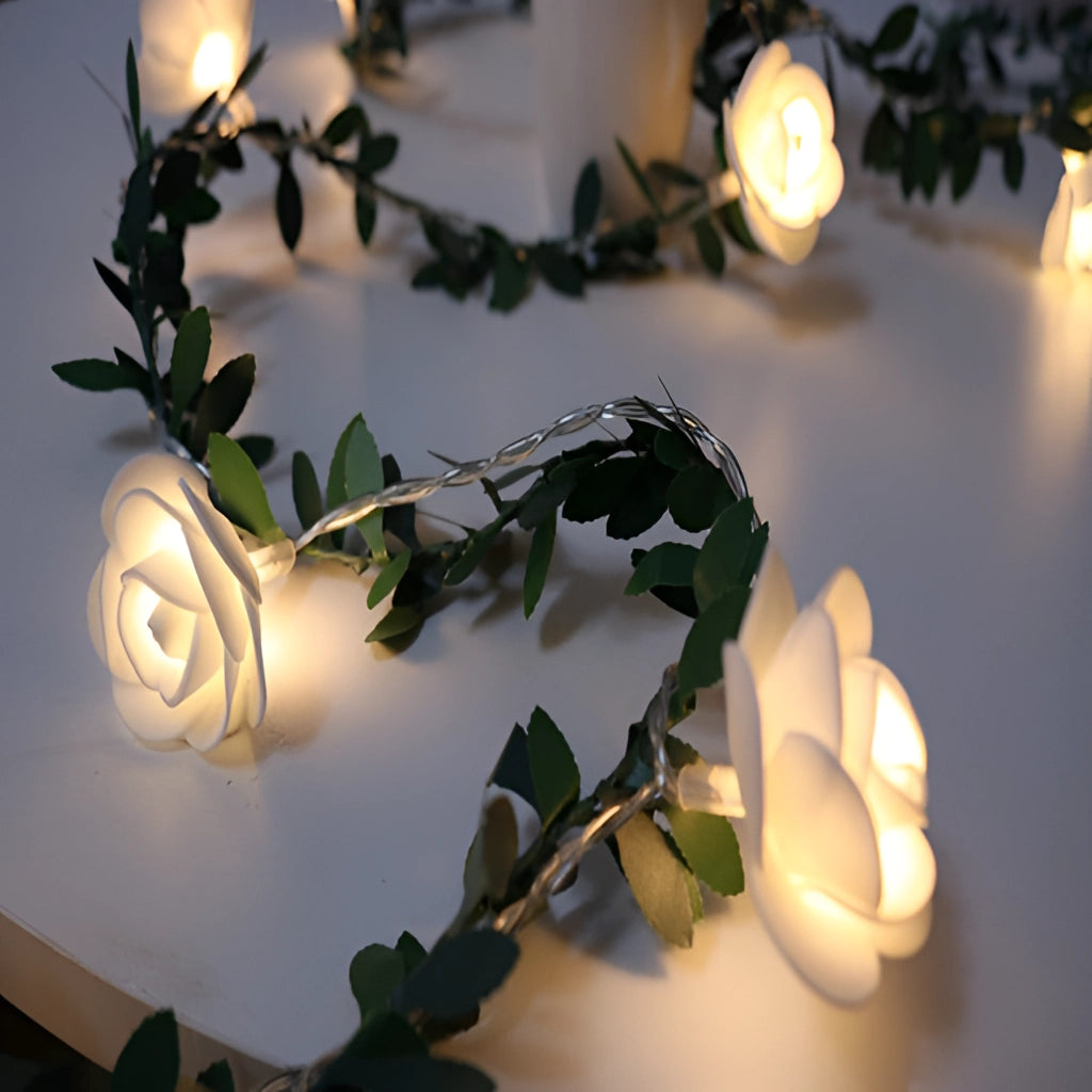 Battery operated LED garland with rose flower string lights, featuring delicate petals and branches, perfect for interior design and table decoration.