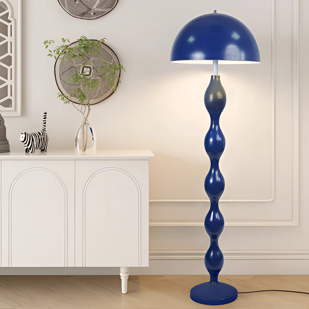 Scandinavian LED floor lamp in blue with adjustable brightness, featuring a Nordic style, placed in a modern interior with white and wooden furniture.