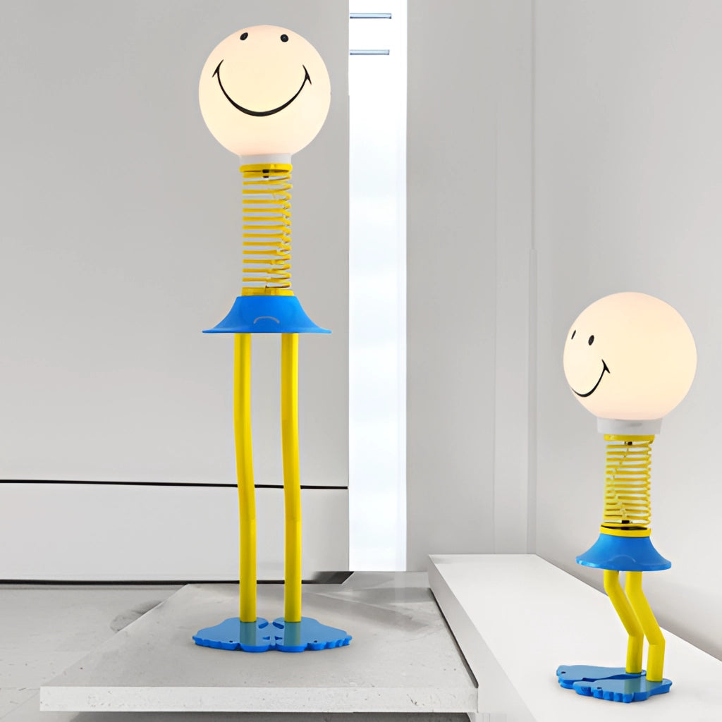 Yellow and blue smiley face design floor lamp with metal and acrylic glass construction, featuring an LED bulb and 110V US plug, suitable for bedroom lighting.