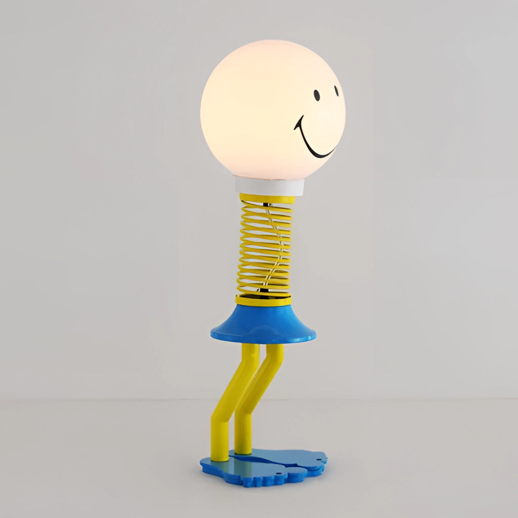 A small floor lamp with a smiley face design in yellow, blue, and white, made of metal, iron, acrylic, and glass, featuring an LED bulb and a 110V US plug, suitable for bedroom lighting.