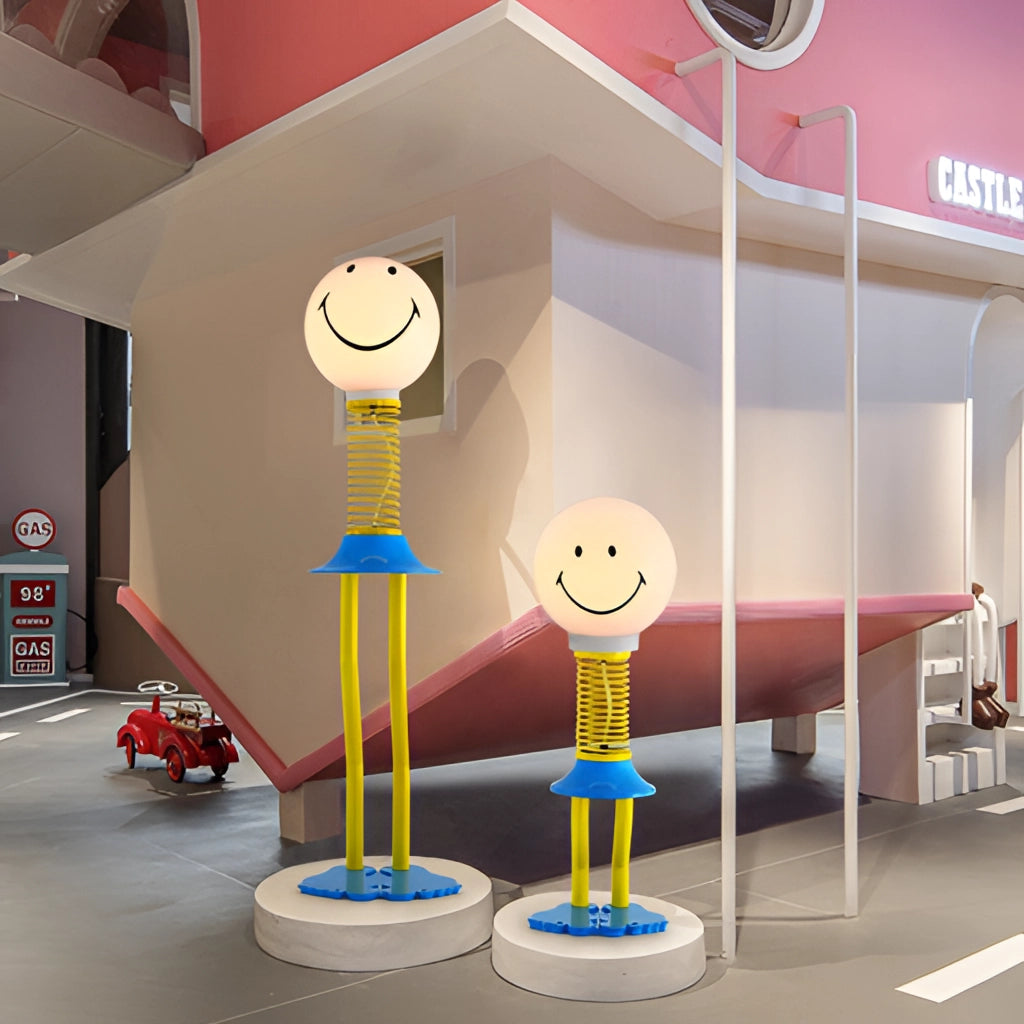 Smiley Face Design Floor Lamp featuring a yellow, blue, and white color scheme, made of metal iron, acrylic, and glass, with an LED bulb and 110V US plug, illuminating a bedroom interior.