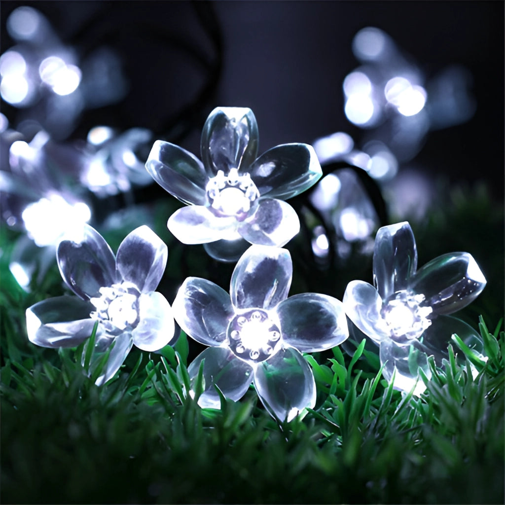 Cherry white solar flower garden LED light strips illuminating a garden with lifelike flower petals and plants.