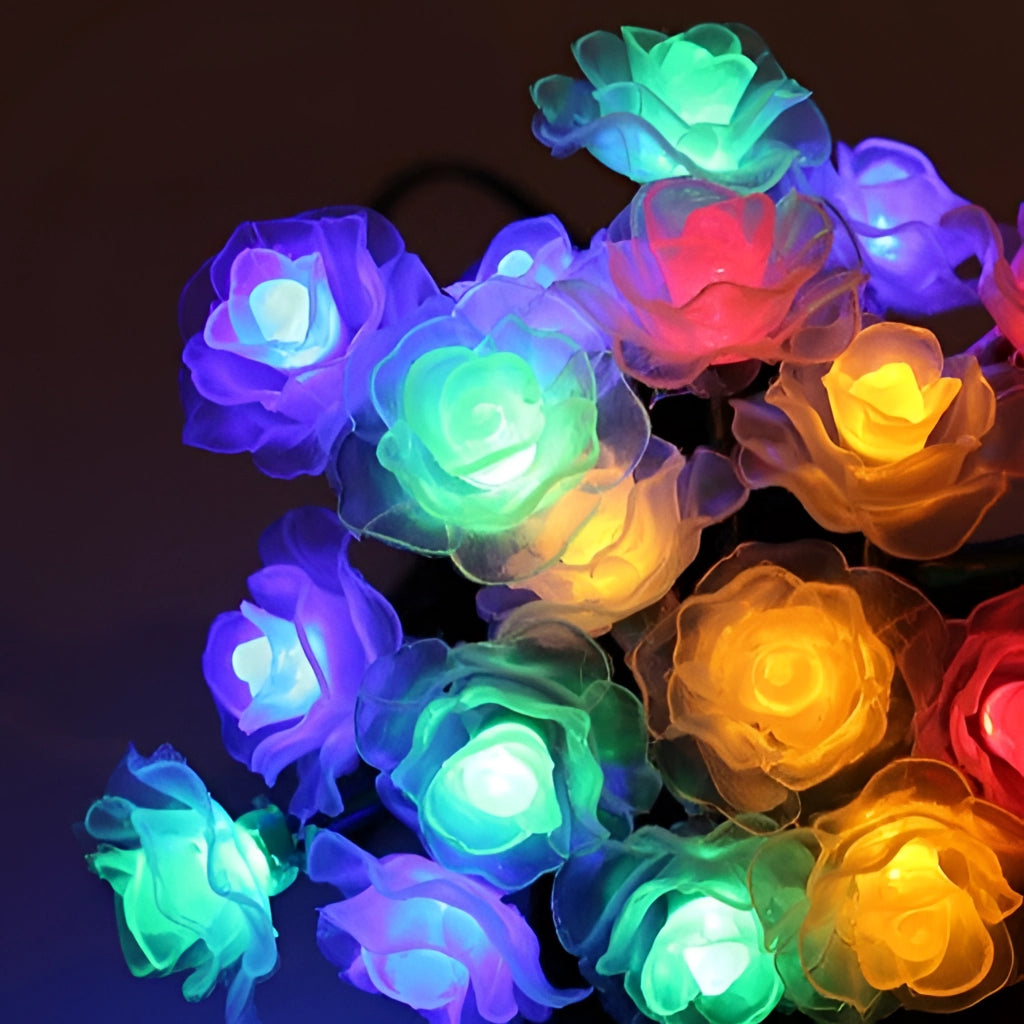 Colorful solar-powered LED light strips shaped like rose petals, emitting vibrant purple and magenta hues.