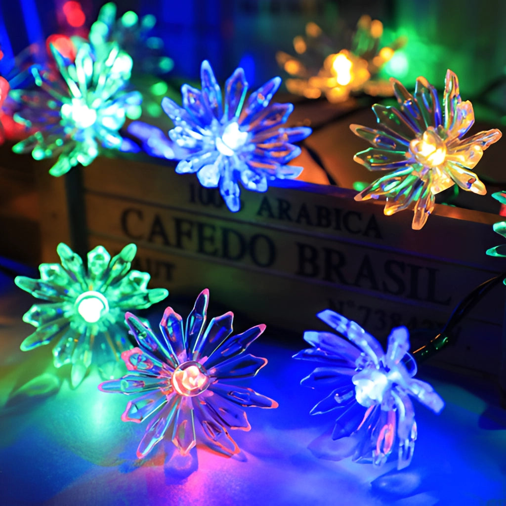 Solar Flower Garden LED Light Strips in chrysanthemum color illuminating a garden with blue and purple hues.