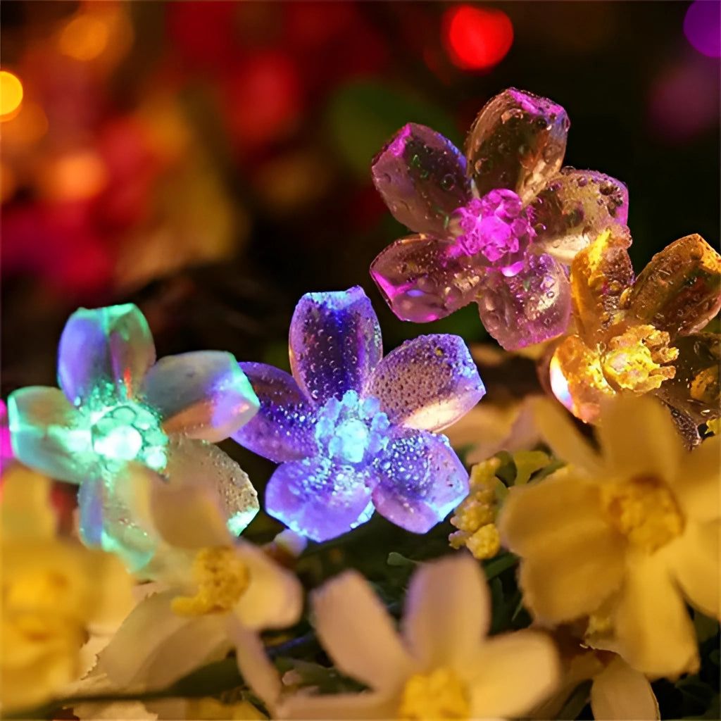Solar Flower Garden LED Light Strips illuminating purple and white flowers with vibrant petals.
