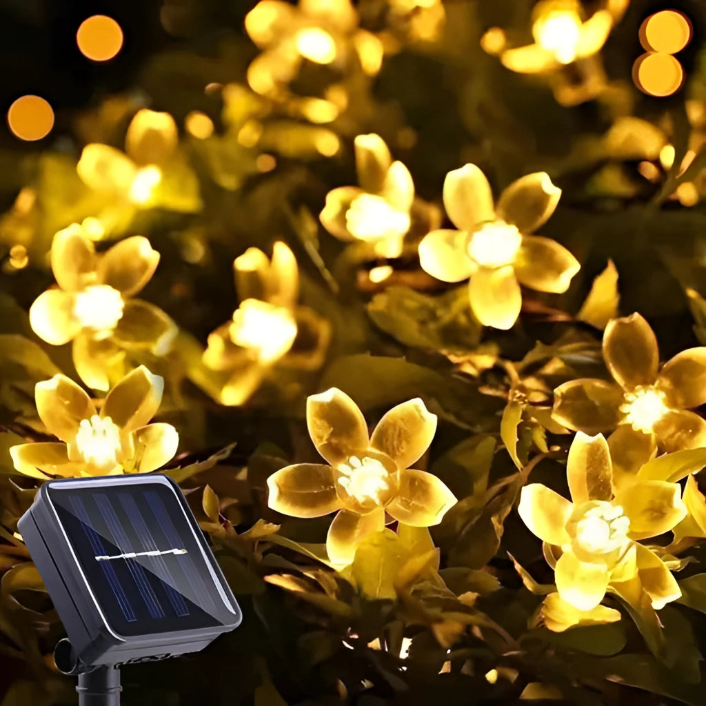 Warm white solar flower string lights featuring crystal peach blossom design, 39ft length with 100 LEDs, displayed outdoors in decorative arrangement.