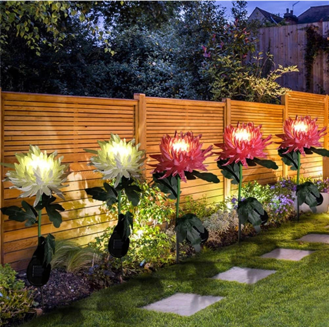 Solar LED Crown Imperial Flower Lights illuminating a garden landscape with vibrant flora and greenery.