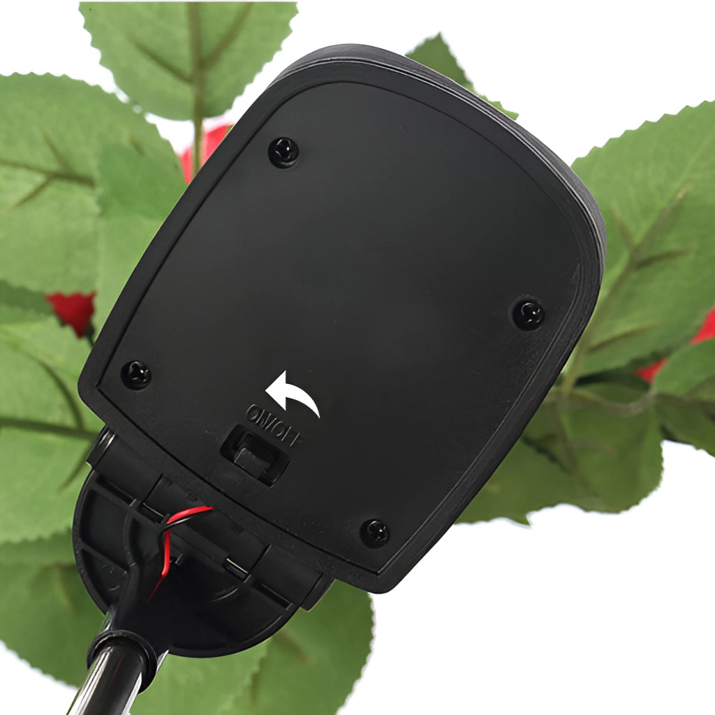 White solar-powered LED rose lights, twin pack, illuminating a garden at night.