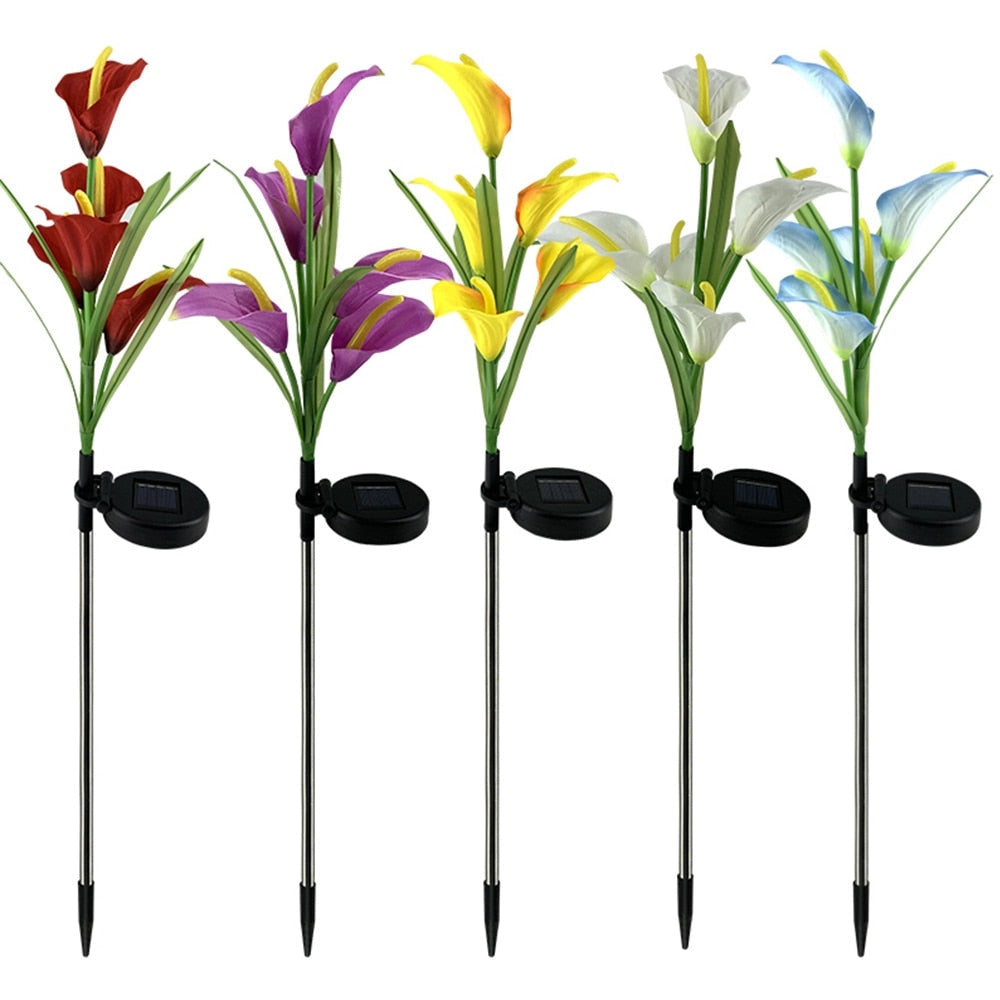 Set of 4 solar lily garden lights with multi-color LEDs, resembling vibrant flowers with detailed petals in a garden setting.